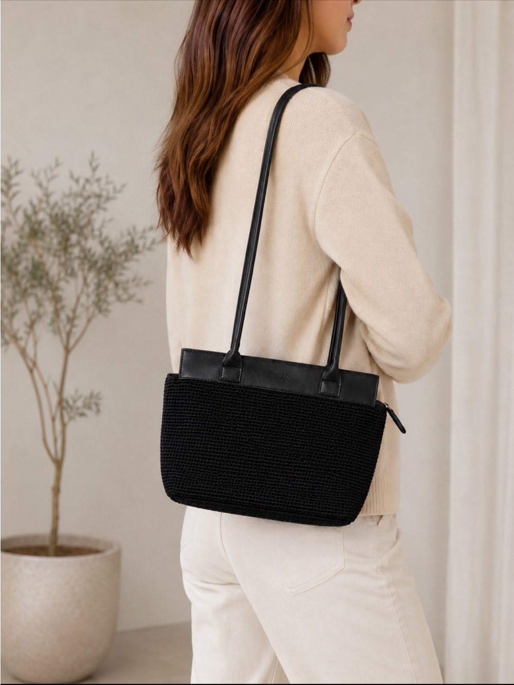 The Sak Crochet Black Shoulder Bag zippered with a snap